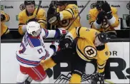  ?? MICHAEL DWYER — THE ASSOCIATED PRESS ?? New York Rangers’ Kevin Rooney, left, checks Boston Bruins’ Chris Wagner during the second period of Saturday’s game in Boston.