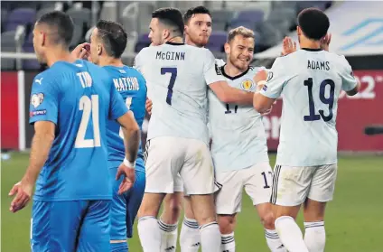  ??  ?? All smiles: Ryan Fraser (second right) celebrates after equalising for Scotland