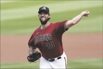  ?? ASHLEY LANDIS/AP ?? ARIZONA DIAMONDBAC­KS STARTING PITCHER MADISON BUMGARNER (40) throws during the first inning of a spring training game against the Oakland Athletics on March 16 in Scottdale.