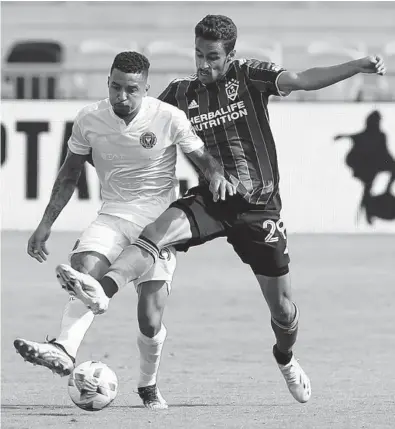  ?? JOHN MCCALL/SOUTH FLORIDA SUN SENTINEL PHOTOS ?? Inter Miami’s Gregore tries to control the ball with LA Galaxy’s Ethan Zubak on defense during the second half Sunday at DRV PINK Stadium in Fort Lauderdale.