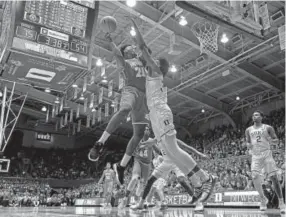  ?? Grant Halverson, Getty Images ?? Southern’s Patrick Smith puts up a shot against Duke’s Marvin Bagley III on Friday night at Cameron Indoor Stadium.