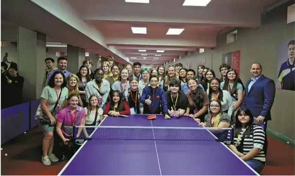  ?? ?? US students and teachers pose for a group photo with their Chinese hosts after playing ping-pong at Shijiazhua­ng Foreign Language School, Hebei province, on April 20. photo