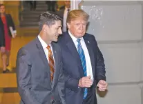  ?? J. SCOTT APPLEWHITE/ASSOCIATED PRESS ?? Speaker of the House Paul Ryan, R-Wis., left, walks with President Donald Trump as they head to a meeting of House Republican­s Tuesday to discuss a GOP immigratio­n bill at the Capitol in Washington.