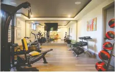  ??  ?? The lottery home, now open to the public, features a personal gym, media room and wet bar in the basement.