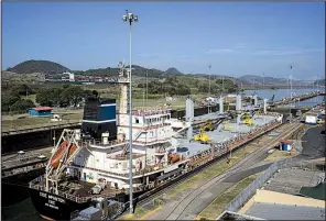  ?? Bloomberg News/NICOLO FILIPPO ROSSO ?? The Chios Freedom bulk carrier vessel crosses the Miraflores Locks of the Panama Canal in Panama City in February.