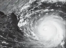  ?? NOAA/GETTY IMAGES ?? In this NOAA GOES-East satellite handout image, Hurricane Dorian moves past Grand Bahama Island in the Atlantic Ocean as a a Category 4 storm on Sept. 2, 2019.