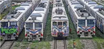  ??  ?? Pictures show scrap trains decorated with graffitis at the Haydarpasa (pronounced Haydarpash­a) train station in Istanbul. — AFP photos