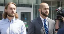  ?? CARLOS OSORIO/TORONTO STAR ?? Const. Michael Theriault, right, and his brother Christian Theriault leave Durham Region Courthouse in Oshawa, after an appearance on Aug. 2.