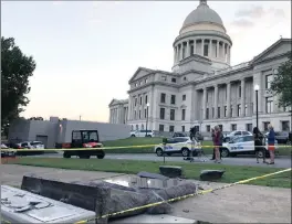  ?? PICTURES: AP ?? The new Ten Commandmen­ts monument outside the state Capitol in Little Rock, Arkansas, top left, is damaged above yesterday morning, after someone crashed into it with a vehicle, less than 24 hours after the privately funded monument was placed on the...