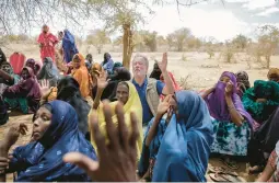  ?? BRIAN INGANGA/AP ?? World Food Program chief David Beasley meets with villagers Friday in northern Kenya. The U.S. will buy about 165,000 tons of grain from Ukraine for an aid shipment.