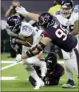  ?? DAVID J. PHILLIP — THE ASSOCIATED PRESS ?? Tennessee Titans running back Dion Lewis (33) is stopped by Houston Texans defensive end J.J. Watt (99) during the first half of an NFL football game Monday in Houston.