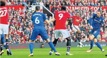  ?? Picture: GETTY IMAGES ?? ON THE MONEY: Antonio Valencia, second from right, of Manchester United lets rip to hand the Red Devils their first goal during the Premier League match against Everton at Old Trafford. United pulled off a great 4-0 win in a match which pleased coach...