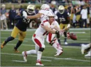  ?? CHARLES REX ARBOGAST — THE ASSOCIATED PRESS ?? Miami quarterbac­k Gus Ragland tosses the ball to running back Kenny Young during the first half against Notre Dame on Sept. 30 in South Bend, Ind.