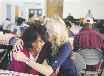  ?? Photograph­s by Dania Maxwell Los Angeles Times ?? AMIE QUIGLEY, right, comforts Charva Harris during a mental health clinic at First Presbyteri­an Church of Hollywood, which is surrounded by encampment­s. Quigley has aided Harris for many years.