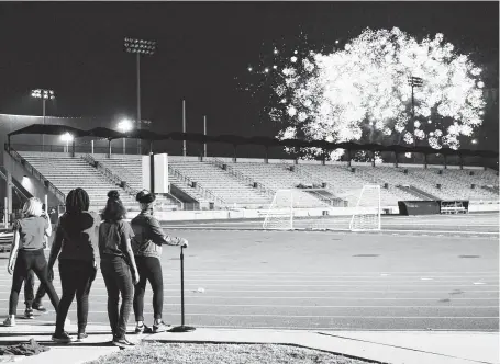  ?? Kaila Contreras / Staff photograph­er ?? Woodcreek Middle School students gather to watch fireworks at Humble ISD’s Centennial Celebratio­n on Saturday night. Light shows bookended the festivitie­s, which also featured pastor Joel Osteen and musician Gary Kyle, both Humble ISD graduates.