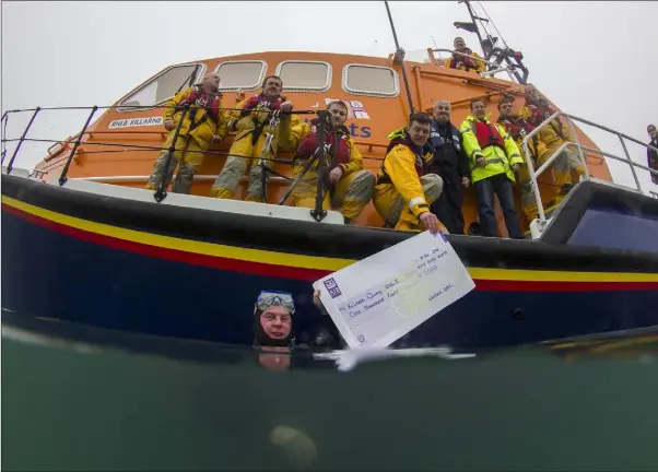  ??  ?? The handing-over of the cheque from Wexford Sub Aqua Club to the Kilmore Quay branch of the RNLI (from left): Tony Parle, Trevor Devereux, Niall McGee, Michael Rossiter, Derek McDonnell (in water), Johnny Moore, Nick Kendall, Sam Nunn, Alan Hinchy, and...