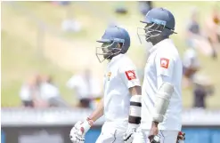  ?? — AFP photo ?? Sri Lanka's batsmen Kusal Mendis (L) and Angelo Mathews leave the field at lunch during day four of the first Test cricket match between New Zealand and Sri Lanka at the Basin Reserve in Wellington on December 18, 2018.