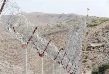  ??  ?? A view of the border fence outside the Kitton outpost on the border with Afghanista­n in North Waziristan, Pakistan.