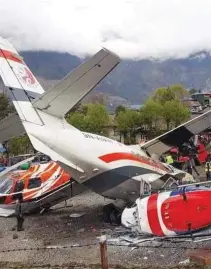  ?? – Supplied photo ?? CRASH: A Summit Air plane collided with a Manang Air helicopter that was parked at Lukla airport in Nepal.