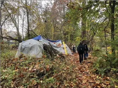  ?? RACHEL RAVINA - MEDIANEWS GROUP ?? Representa­tives of the Street Medicine team walk toward a tent during their first outing on Nov. 1in Norristown.