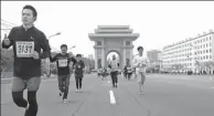  ?? JON CHOL-JIN / ASSOCIATED PRESS ?? Runners compete in the Pyongyang Internatio­nal Marathon under the backdrop of the Arch of Triumph in the DPRK capital on Sunday.