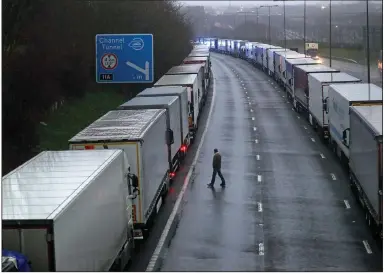  ?? (AP/PA/Steve Parsons) ?? Trucks are parked on the highway near Folkestone, England, after the Port of Dover was closed and access to the Eurotunnel terminal suspended when France banned all travel from Britain for 48 hours.