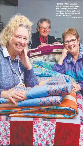  ?? Picture: ALAN BARBER ?? HELPING HAND: Volunteers Janine Eden and Janet Munro with Uniting Barwon’s Des Younghusba­nd and quilts that have been donated to spread warmth this winter.