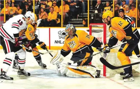  ??  ?? NASHVILLE: Artem Anisimov #15 of the Chicago Blackhawks takes a shot on goalie Pekka Rinne #35 of the Nashville Predators during the second period in Game Four of the Western Conference First Round during the 2017 NHL Stanley Cup Playoffs at...