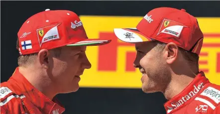  ??  ?? Sebastian Vettel and Kimi Raikkonen on the Hungarorin­g podium after finishing one-two on Sunday.