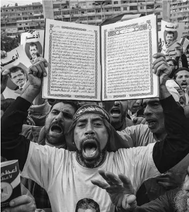  ?? DANIEL BEREHULAK/ GETTY IMAGES ?? Supporters of Egyptian President Mohamed Morsi chant slogans during a rally in Cairo on Friday.