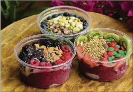  ??  ?? For a healthful option, combine various fruits, greens and sweet toppings and try the Smooth Move’s build-your-own bowls ($8 per 8-ounce bowl).