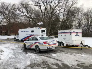  ??  ?? In this Feb. 3 file photo, police vehicles are parked outside a property where they say they have recovered the remains of at least six people from planters on the property which is connected to alleged serial killer Bruce McArthur, in Toronto, Canada....