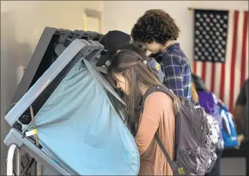  ?? Allen J. Schaben Los Angeles Times ?? PEOPLE CAST ballots Thursday at an early-voting center at UC Irvine, ahead of election day on Tuesday.