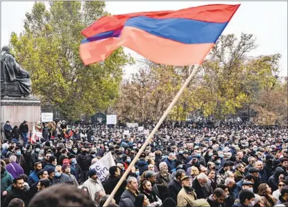  ?? KAREN MINASYAN AFP VIA GETTY IMAGES ?? A man waves a flag of the Nagorno-karabakh region during a rally Saturday calling for Armenia’s prime minister to resign.