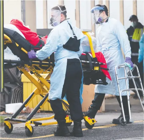  ?? Graham Hughes / THE CANADIAN PRESS ?? Paramedics transfer a person from Maimonides Geriatric Centre in Montreal on Sunday as COVID-19 cases continue to rise in Canada and around the world. Vaccine maker Moderna says
Canada is near the front of the line to receive 20 million doses of its vaccine.