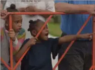  ??  ?? Zanai and Kara Edwards watch the third annual Coatesvill­e Grand Prix Saturday.