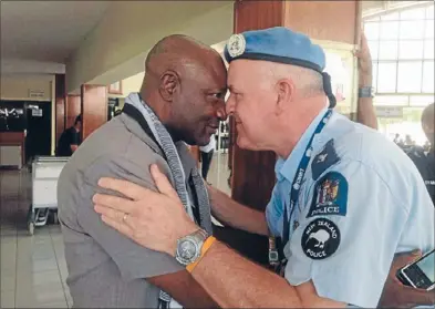  ??  ?? Kiwi greeting: Meeting internatio­nal police officers was a highlight of Porirua police officer John Spence’s time in Timor – here he shares a hongi with a Nigerian colleague.