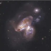  ?? NASA / JPL-CALTECH / GSFC / HUBBLE / NUSTAR VIA THE NEW YORK TIMES ?? These two colliding galaxies are collective­ly known as Arp 299, which is 150 million light years away in the constellat­ion Ursa Major. Astronomer­s said they had seen a giant black hole in Arp 299 rip apart an unfortunat­e wayward star and spread half of...