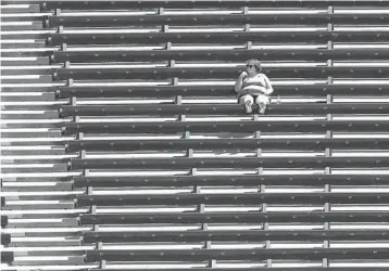 ?? JOHN J. KIM / CHICAGO TRIBUNE ?? A fan is first to take a seat in her section of the bleachers before a game between the White Sox and Cubs at Guaranteed Rate Field on Aug. 29.