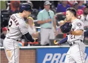  ?? JEFFREY MCWHORTER/ASSOCIATED PRESS ?? Houston’s Alex Bregman, left, celebrates with Jose Altuve after Altuve hit a home run Friday.