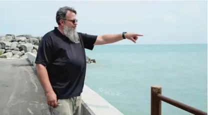  ?? PAT NABONG/SUN-TIMES ?? John Gulledge, the chief water plant operator for the city of Lake Forest, looks out over Lake Michigan outside the Lake Forest Water Treatment Plant last week.