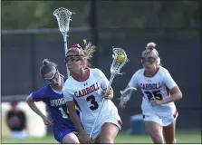  ?? PETE BANNAN — MEDIANEWS GROUP ?? Archbishop Carroll’s Chloe Beckley, right, carries the ball against Springfiel­d in the first half Thursday. The Patriots won, 13-9, to finish the regular season undefeated.