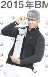  ??  ?? SHANGHAI: Kristoffer Broberg of Sweden reacts while holding his champion trophy during the award ceremony of the BMW Masters golf tournament at the Lake Malaren Golf Club in Shanghai, China yesterday. — AP