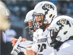  ??  ?? Colorado quarterbac­k Steven Montez talks with teammates before Saturday’s game at Oregon. Thomas Boyd, The Associated Press