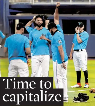  ?? AMY BETH BENNETT/SOUTH FLORIDA SUN SENTINEL ?? ABOVE: Marlins pitchers including Sandy Alcantara (22), center, and Yimi García (93) warm up at loanDepot park in Miami on Wednesday.