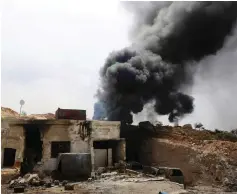  ?? (Reuters) ?? SMOKE RISES from an emergency service point after an air strike at the rebel-held village of Maar Zita in Syria yesterday.