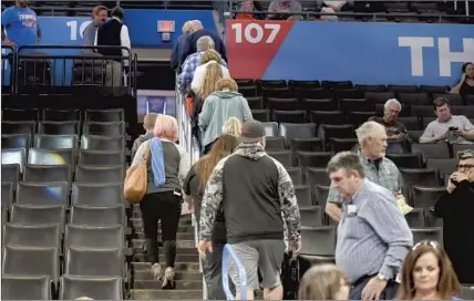  ?? Kyle Phillips Associated Press ?? FANS FILE OUT of Chesapeake Energy Arena on March 11 after an announceme­nt that Oklahoma City’s game against Utah was postponed. Less than an hour later, the NBA announced it was suspending its season, and other sports leagues soon followed.