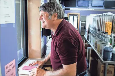  ??  ?? Tommy Flinn, Velvet Cream’s owner, takes an order at the walk up window Thursday at Velvet Cream in DeSoto County. Velvet Cream opened for business on July 23, 1947. PHOTOS BY BRAD VEST/THE COMMERCIAL APPEAL