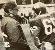  ?? JOHN CIOLINO PHOTO ?? Coach Al Baumgart talks to Jeff Richardson during a Harper Woods Notre Dame game in the 1970s.