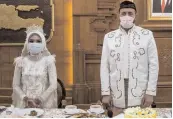  ?? — AFP ?? Indonesian bride Irra Chorina Octora and her Turkish partner Yavuz Ozdemir during their wedding ceremony in Surabaya on Wednesday.